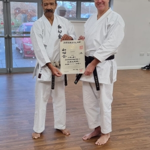 John Bleeker receiving his Sandan certificate from Shihan Thompson