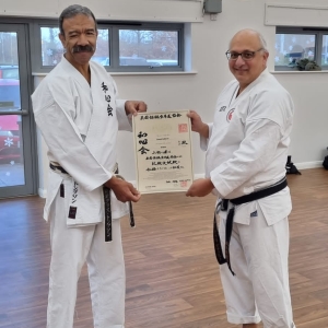 Lionel Zeffert receiving his Godan certificate from Shihan Thompson